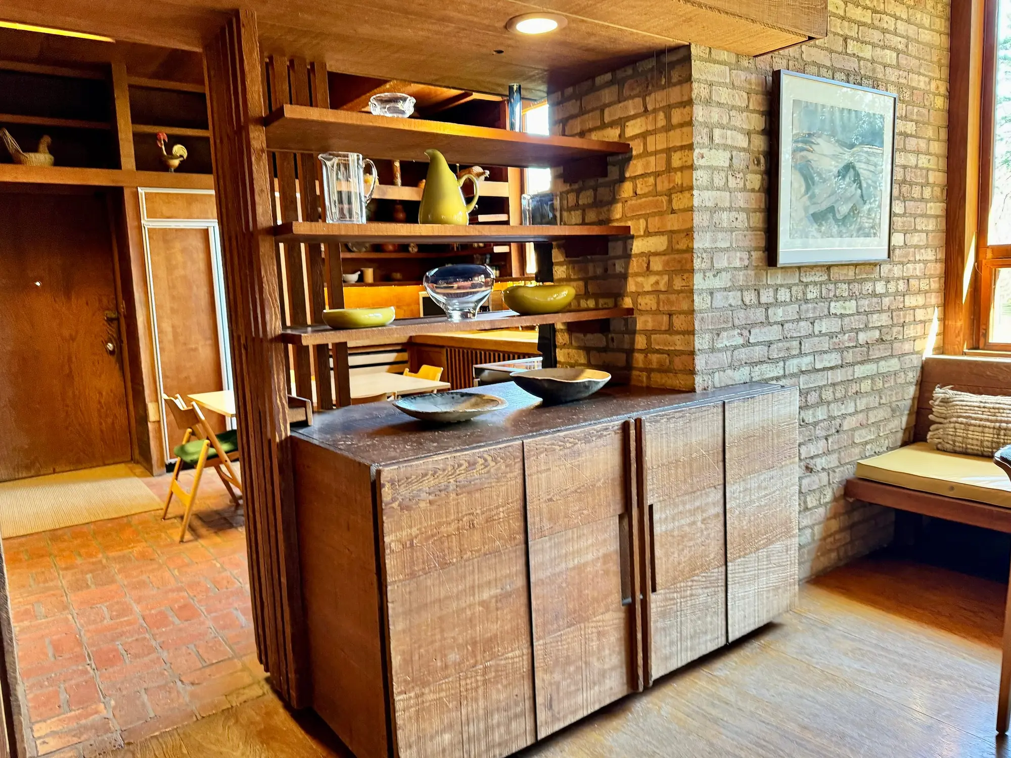 Warm wood-paneled kitchen with open shelves