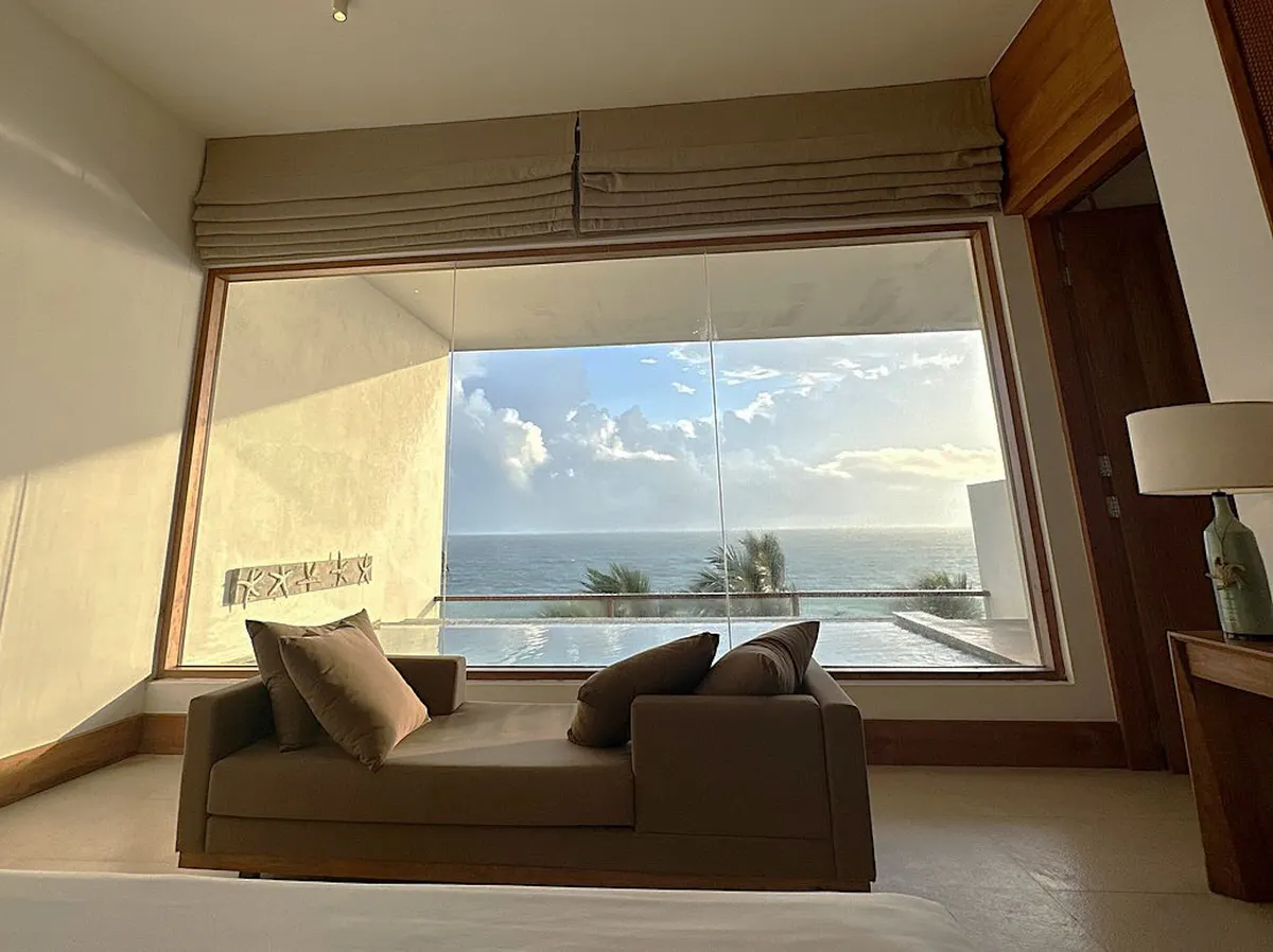 Lounge with a picture window and water view