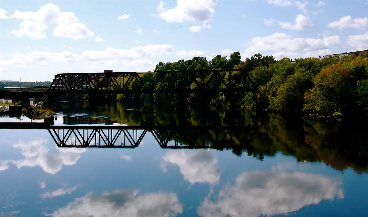 Railroad bridge reflected in the river