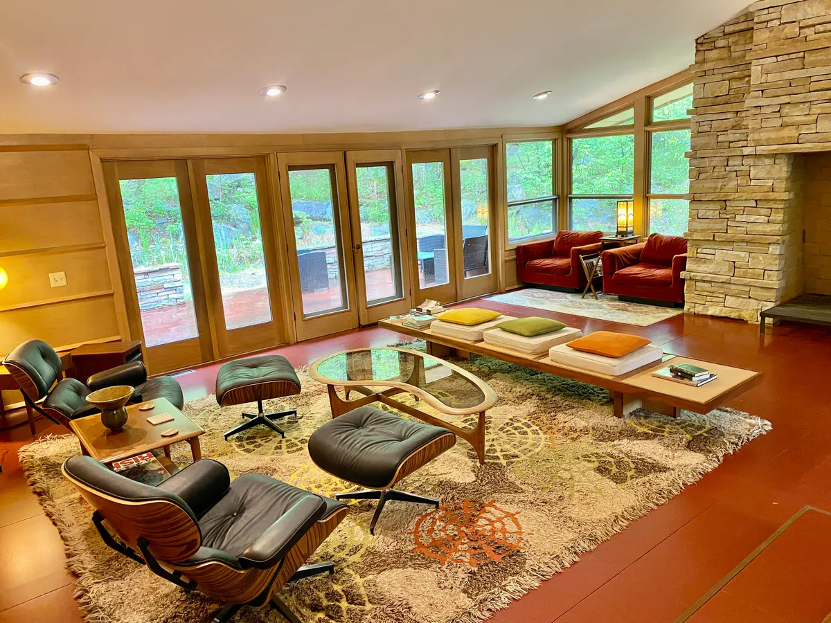 Great room with walls of windows and mid-century furniture
